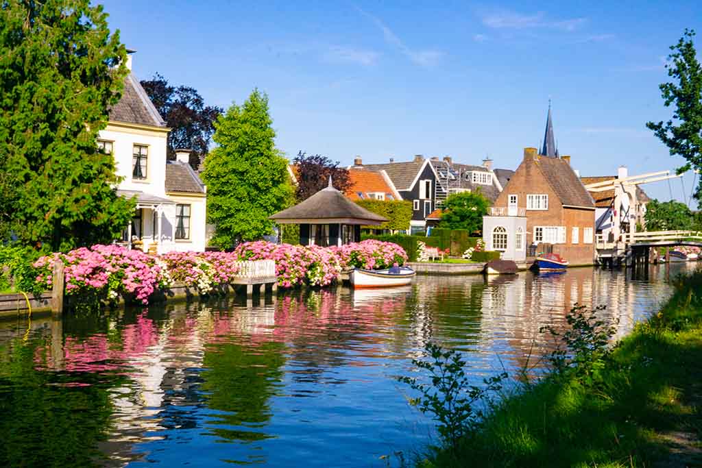 Dutch canal with boats and flowers